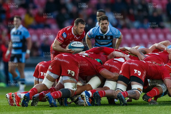 020422 - Scarlets v Cardiff Rugby - United Rugby Championship - Gareth Davies of Scarlets prepares to put the ball into a scrum, watched by Tomos Williams of Cardiff Rugby