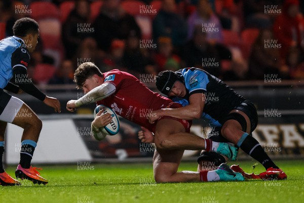 041123 - Scarlets v Cardiff Rugby - United Rugby Championship - Eddie James of Scarlets is tackled by Seb Davies of Cardiff