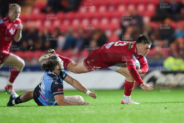 041123 - Scarlets v Cardiff Rugby - United Rugby Championship - Joe Roberts  Scarlets is tackled by Ben Thomas  of Cardiff