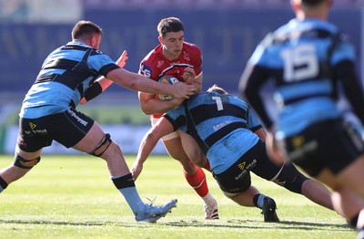 180426 - Scarlets v Cardiff Rugby - United Rugby Championship - Joe Hawkins of Scarlets is tackled by Rhys Barratt of Cardiff 