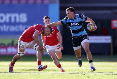 180426 - Scarlets v Cardiff Rugby - United Rugby Championship - Mason Grady of Cardiff is tackled by Jarrod Taylor of Scarlets 