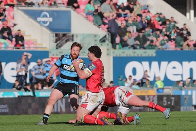 180426 - Scarlets v Cardiff Rugby - United Rugby Championship - Fletcher Anderson of Scarlets offloads under pressure from Rory Jennings of Cardiff Rugby
