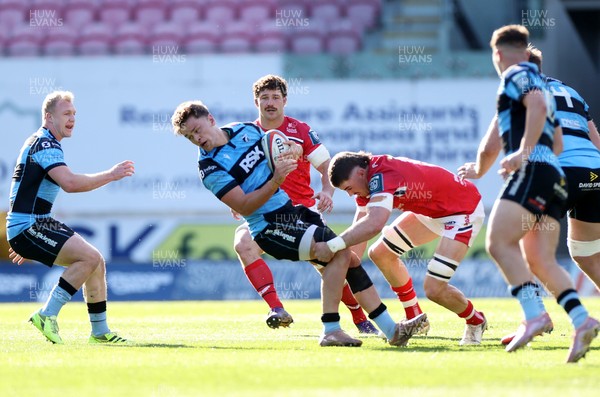 180426 - Scarlets v Cardiff Rugby - United Rugby Championship - Alex Mann of Cardiff is tackled by Fletcher Anderson of Scarlets 