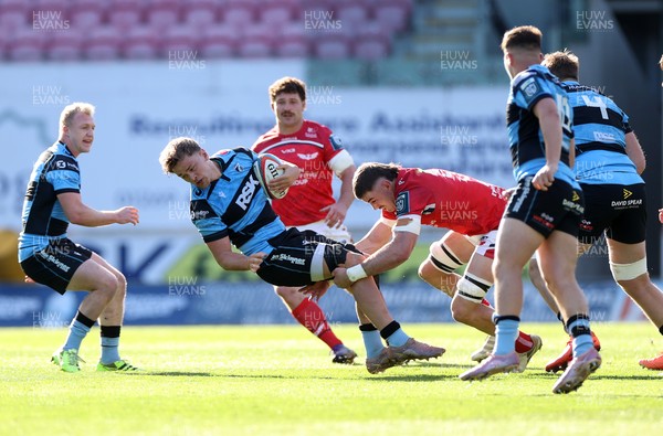 180426 - Scarlets v Cardiff Rugby - United Rugby Championship - Alex Mann of Cardiff is tackled by Fletcher Anderson of Scarlets 