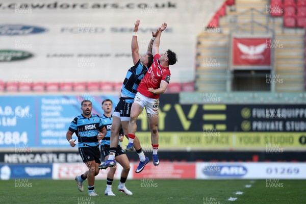 180426 - Scarlets v Cardiff Rugby - United Rugby Championship - Tom Rogers of Scarlets and Mason Grady of Cardiff Rugby challenge for a high ball