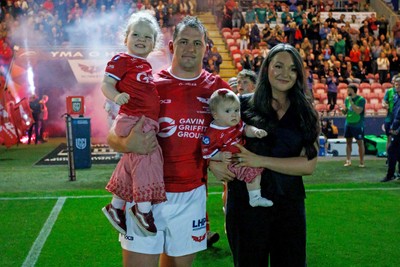 260926 - Scarlets v Cardiff Rugby - United Rugby Championship - Ryan Elias of Scarlets comes out onto the pitch with his wife and children on his 250th appearance for the Scarlets