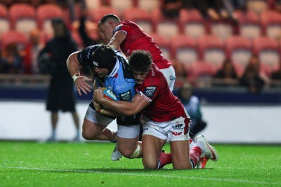 260926 - Scarlets v Cardiff Rugby - United Rugby Championship - Efan Lloyd of Cardiff goes over for a try despite the tackle of Eddie James of Scarlets