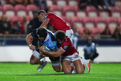 260926 - Scarlets v Cardiff Rugby - United Rugby Championship - Efan Lloyd of Cardiff goes over for a try despite the tackle of Eddie James of Scarlets