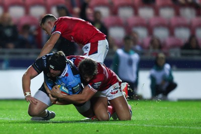 260926 - Scarlets v Cardiff Rugby - United Rugby Championship - Efan Lloyd of Cardiff goes over for a try despite the tackle of Eddie James of Scarlets