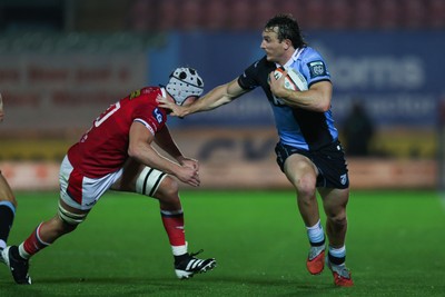 260926 - Scarlets v Cardiff Rugby - United Rugby Championship - Le Roux Malan of Cardiff hands off Tristan Davies of Scarlets
