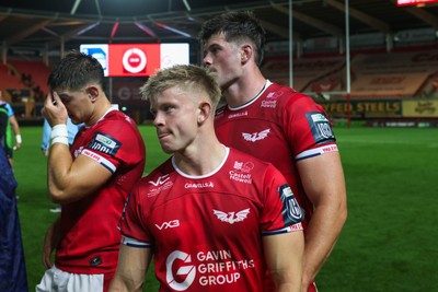 260926 - Scarlets v Cardiff Rugby - United Rugby Championship - Joe Hawkins, Archie Hughes and Tristan Davies of Scarlets look dejected at the end of the match