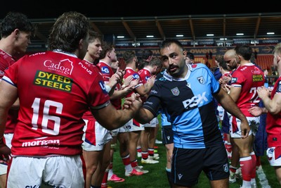 260926 - Scarlets v Cardiff Rugby - United Rugby Championship - Liam Belcher of Cardiff shakes hands with John McKee of Scarlets at the end of the match