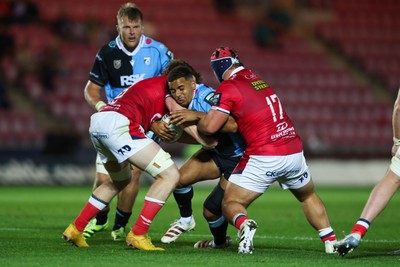 260926 - Scarlets v Cardiff Rugby - United Rugby Championship - Ben Thomas of Cardiff is tackled by Osian Williams and Josh Morse of Scarlets