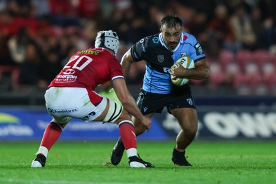 260926 - Scarlets v Cardiff Rugby - United Rugby Championship - Liam Belcher of Cardiff runs at Tristan Davies of Scarlets