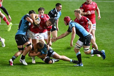 260926 - Scarlets v Cardiff Rugby - United Rugby Championship - Eddie James of Scarlets is challenged by Dan Thomas of Cardiff Rugby