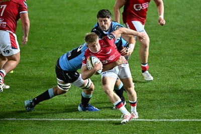 260926 - Scarlets v Cardiff Rugby - United Rugby Championship - Archie Hughes of Scarlets is challenged by James Botham of Cardiff Rugby