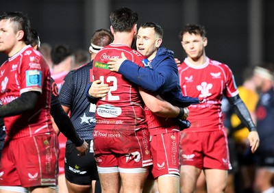 250323 - Scarlets v Sharks - United Rugby Championship - Johnny Williams and Gareth Davies of Scarlets celebrates win