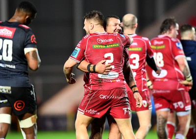 250323 - Scarlets v Sharks - United Rugby Championship - Shaun Evans and Javan Sebastian of Scarlets celebrates win