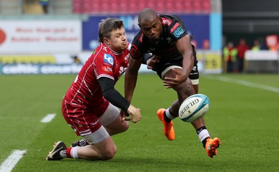 250323 - Scarlets v Cell C Sharks - United Rugby Championship - Makazole Mapimpi of Sharks is tackled by Steff Evans of Scarlets 