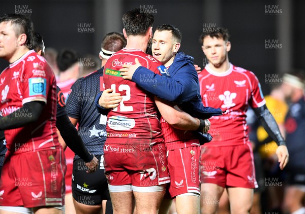 250323 - Scarlets v Sharks - United Rugby Championship - Johnny Williams and Gareth Davies of Scarlets celebrates win