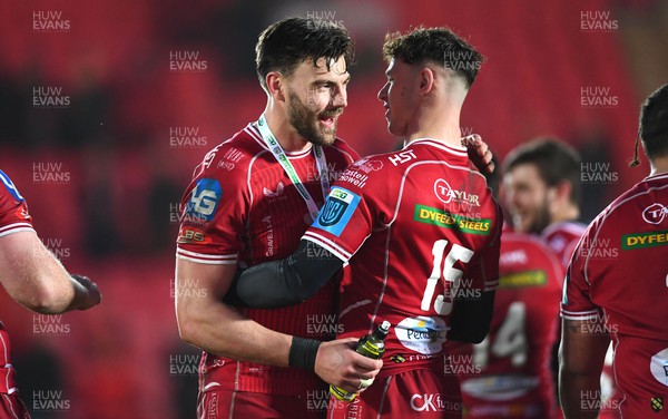 250323 - Scarlets v Sharks - United Rugby Championship - Johnny Williams with Tom Rogers of Scarlets celebrates win