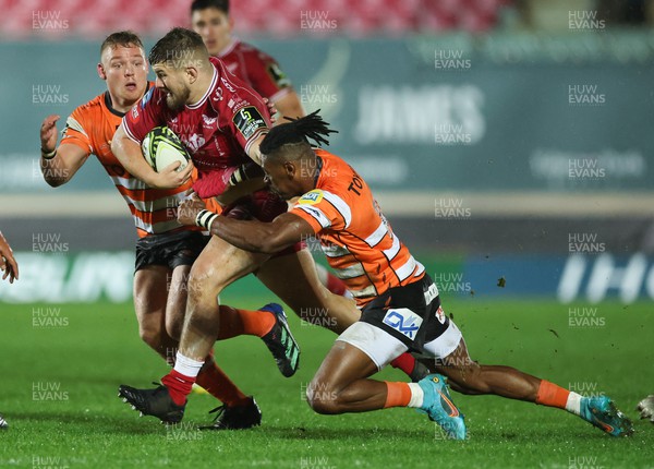 130123 - Scarlets v Toyota Cheetahs, ECPR Challenge Cup - Shaun Evans of Scarlets is tackled