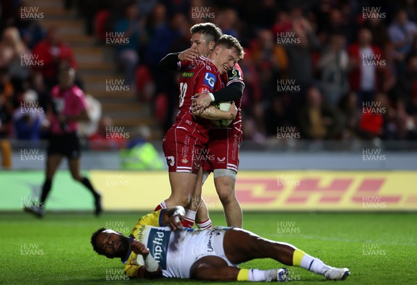 070423 - Scarlets v Clermont Auvergne - European Challenge Cup quarter-final - Sam Costelow of Scarlets celebrates scoring a try with Steff Evans