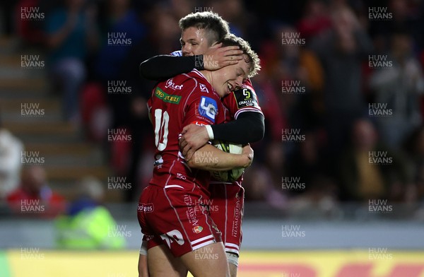 070423 - Scarlets v Clermont Auvergne - European Challenge Cup quarter-final - Sam Costelow of Scarlets celebrates scoring a try with Steff Evans