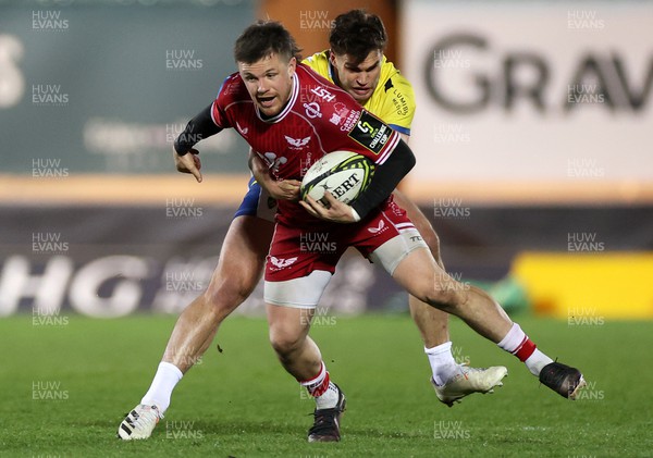 070423 - Scarlets v Clermont Auvergne - European Challenge Cup quarter-final - Steff Evans of Scarlets is tackled by Damian Penaud of Clermont 