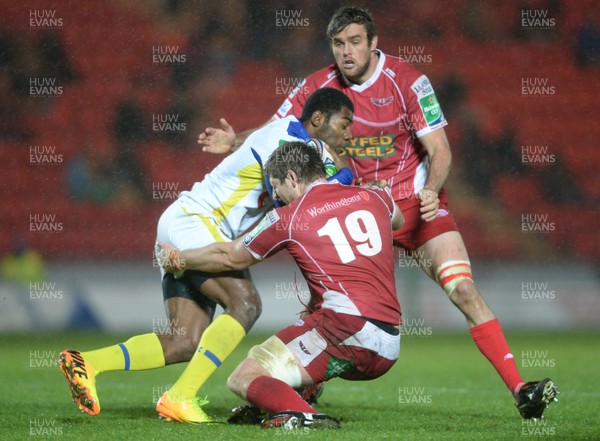 141213 - Scarlets v Clermont Auvergne - Heineken Cup -Noa Nakaitaci of Clermont Auvergne is tackled by Richard Kelly of Scarlets