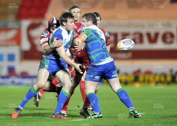 080213 - Scarlets v Connacht - Rabo Direct Pro12 -   Connacht's Kyle Tonetti releases the ball despite the tackle of Scarlets' Emyr Phillips 