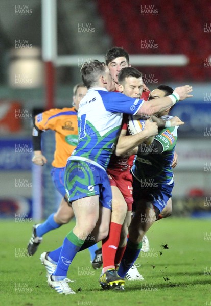 080213 - Scarlets v Connacht - Rabo Direct Pro12 -   Scarlets' Gareth Davies, centre, is tackled by Connacht's Paul O'Donohoe, left, and Miah Nikora