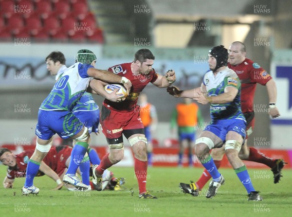 080213 - Scarlets v Connacht - Rabo Direct Pro12 -   Scarlets' Rob McCusker, centre, is tackled by Connacht's Dan Parks and Mick Kearney