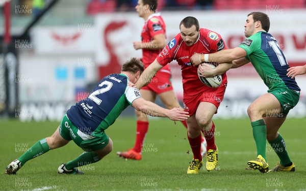 100116 - Scarlets v Connacht - Guinness PRO12 - Ken Owens of Scarlets is tackled by Tom McCartney and Craig Ronaldson of Connacht