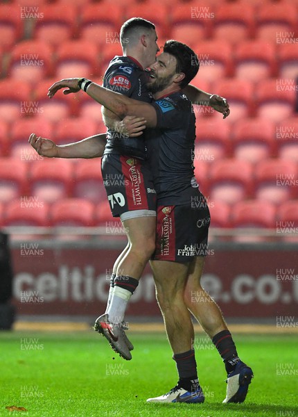 190222 - Scarlets v Connacht - United Rugby Championship - Johnny Williams of Scarlets celebrates scoring try with Dane Blacker (left)
