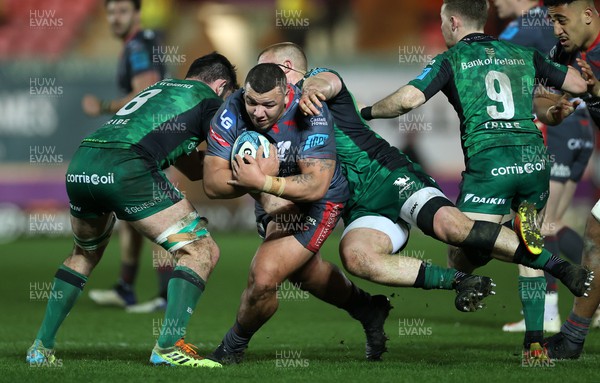 190222 - Scarlets v Connacht - United Rugby Championship - Javan Sebastian of Scarlets is tackled by Dave Heffernan of Connacht
