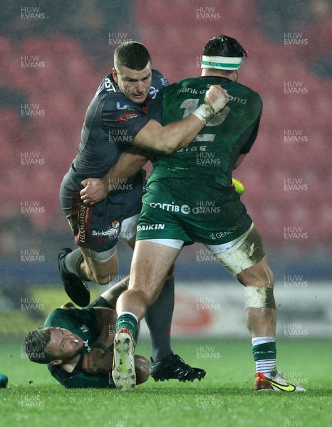 190222 - Scarlets v Connacht - United Rugby Championship - Scott Williams of Scarlets is tackled by Tom Daly of Connacht