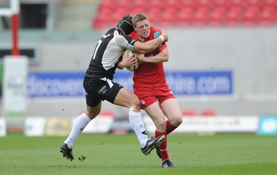 25.04.10 -  Scarlets v Connacht - Magners League - Rhys Priestland of Scarlets is tackled by Ray Ofisa of Connacht. 