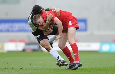 25.04.10 -  Scarlets v Connacht - Magners League - Rhys Priestland of Scarlets is tackled by Ray Ofisa of Connacht. 