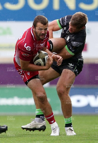 280919 - Scarlets v Connacht - Guinness PRO14 - Paul Asquith of Scarlets is tackled by Tom Daly of Connacht