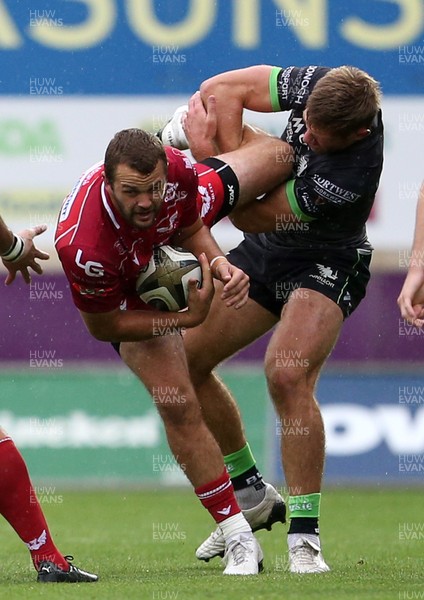 280919 - Scarlets v Connacht - Guinness PRO14 - Paul Asquith of Scarlets is tackled by Tom Daly of Connacht