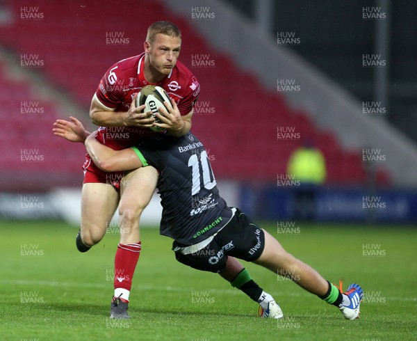 280919 - Scarlets v Connacht - Guinness PRO14 - Johnny McNicholl of Scarlets is tackled by Conor Fitzgerald of Connacht