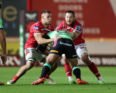 101025 - Scarlets v DHL Stormers - United Rugby Championship - Jarrod Taylor and Marnus van der Merwe of Scarlets tackle JJ Kotze of Stormers 