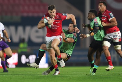 101025 - Scarlets v DHL Stormers, United Rugby Championship -Johnny Williams of Scarlets takes on Ruhan Nel of Stormers and Wandisile Simelane of Stormers