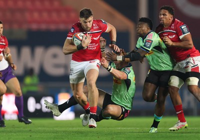 101025 - Scarlets v DHL Stormers, United Rugby Championship -Johnny Williams of Scarlets takes on Ruhan Nel of Stormers and Wandisile Simelane of Stormers