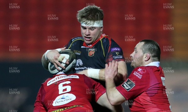 050119 - Scarlets v Dragons - Guinness PRO14 - Aaron Wainwright of Dragons is tackled by Ed Kennedy and Ken Owens of Scarlets