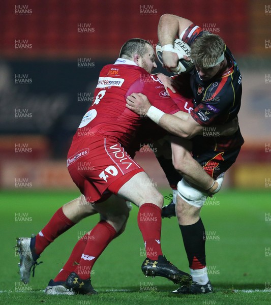 050119 - Scarlets v Dragons - Guinness PRO14 - Aaron Wainwright of Dragons is tackled by Ed Kennedy and Ken Owens of Scarlets