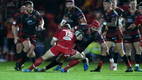 050119 - Scarlets v Dragons - Guinness PRO14 - Cory Hill of Dragons is tackled by Hadleigh Parkes of Scarlets