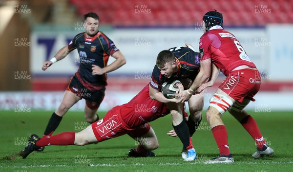 050119 - Scarlets v Dragons - Guinness PRO14 - Jack Dixon of Dragons is tackled by Ken Owens and Ed Kennedy of Scarlets