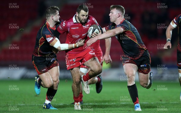 050119 - Scarlets v Dragons - Guinness PRO14 - Paul Asquith of Scarlets is tackled by Hallam Amos and Jack Dixon of Dragons